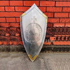 Decorative shield with emblem against a red brick wall