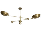 Brass chandelier with four arms on a plain background