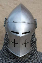 Metallic chainmail helmet with a pointed visor on a neutral background