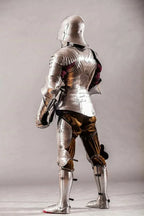 Full suit of medieval armor on a gray background