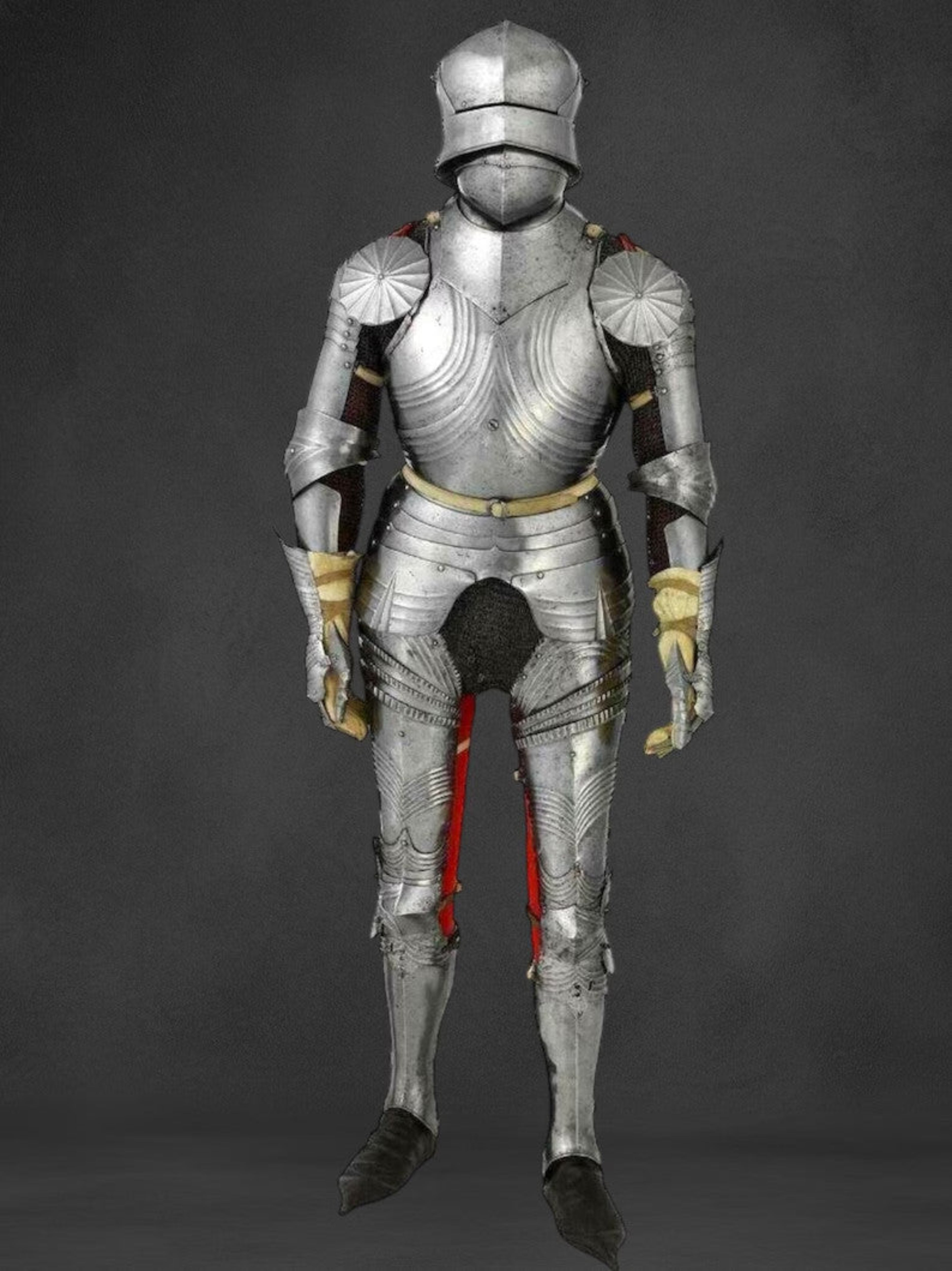 Full suit of medieval armor on a dark background