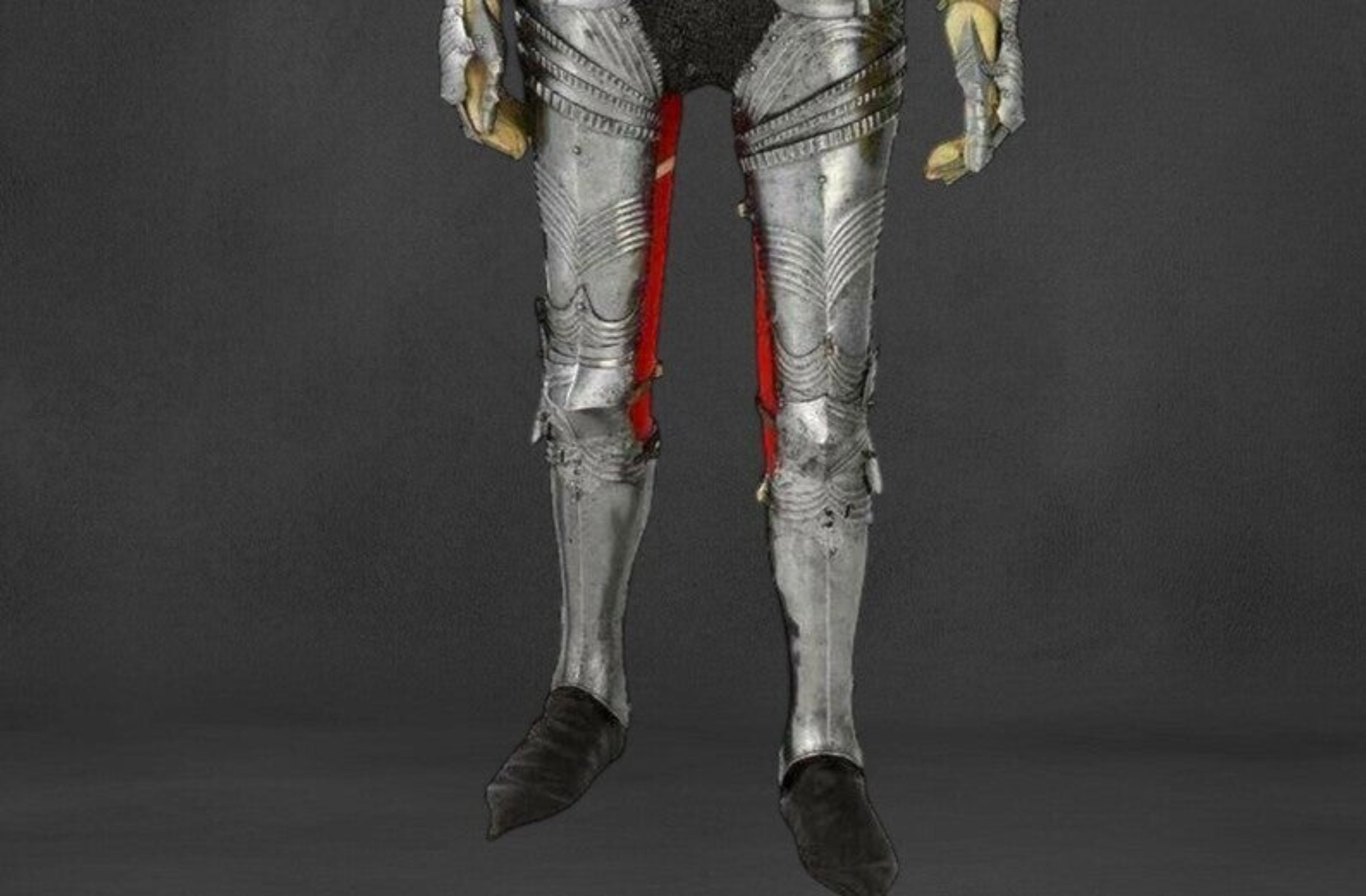 Metallic armor with red accents on a dark background