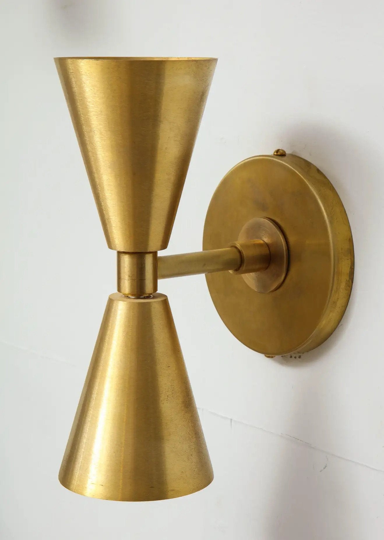 Gold wall sconce on a white background