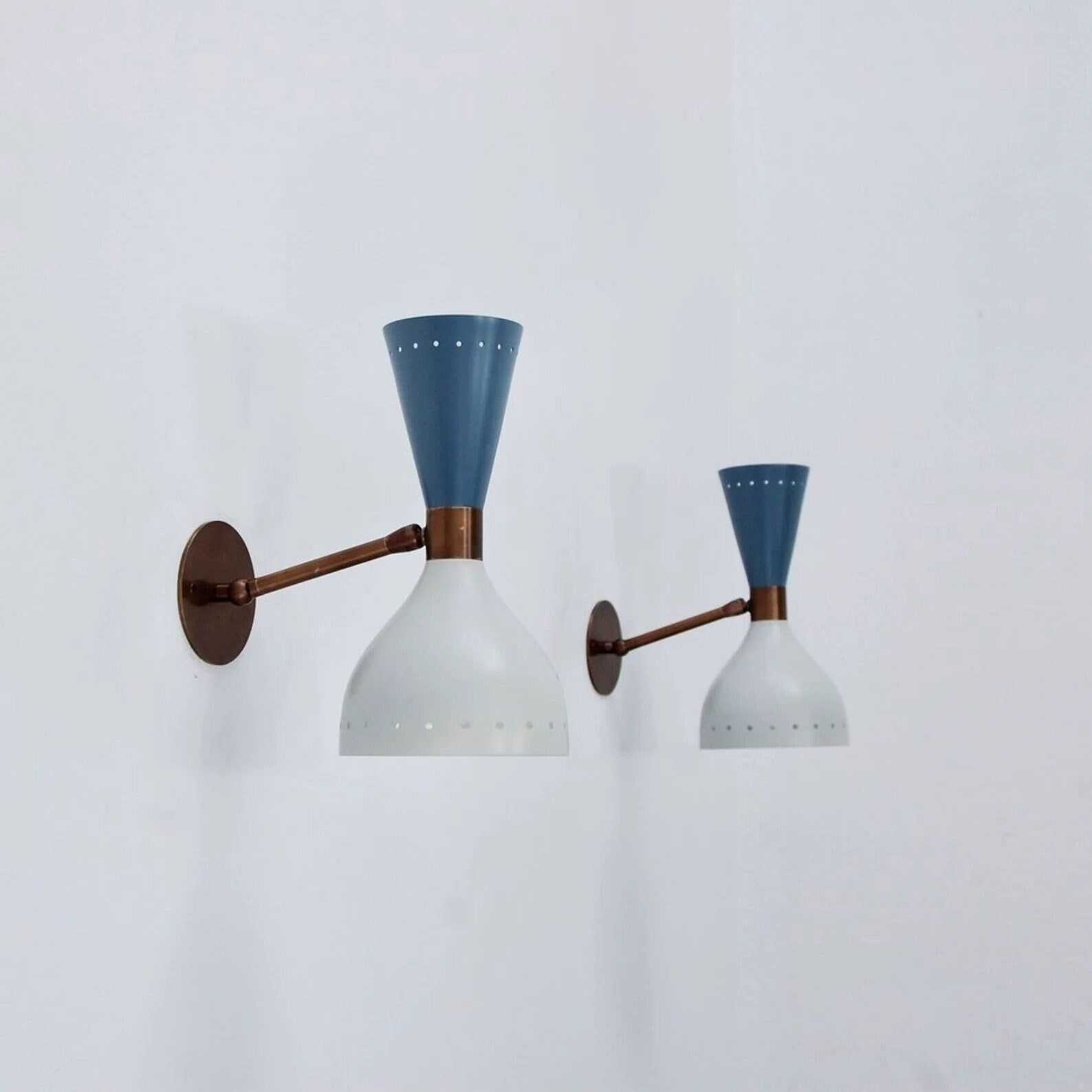 Pair of wall lights with blue and white design on a light gray background