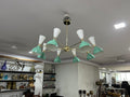 Modern chandelier with green and white design in a room setting