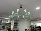 Modern chandelier with green and white design in a room setting