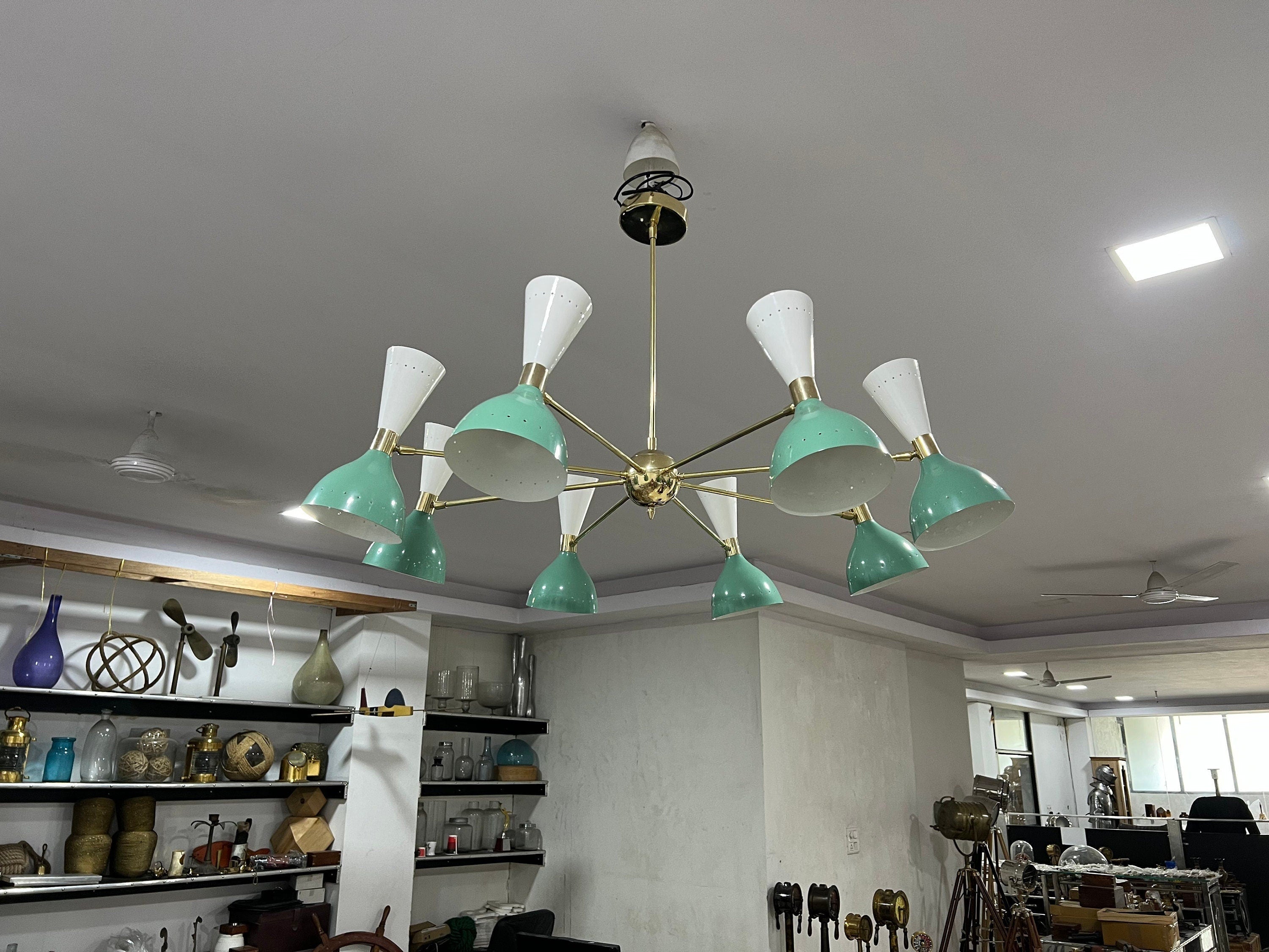 Modern chandelier with green and white design in a room setting