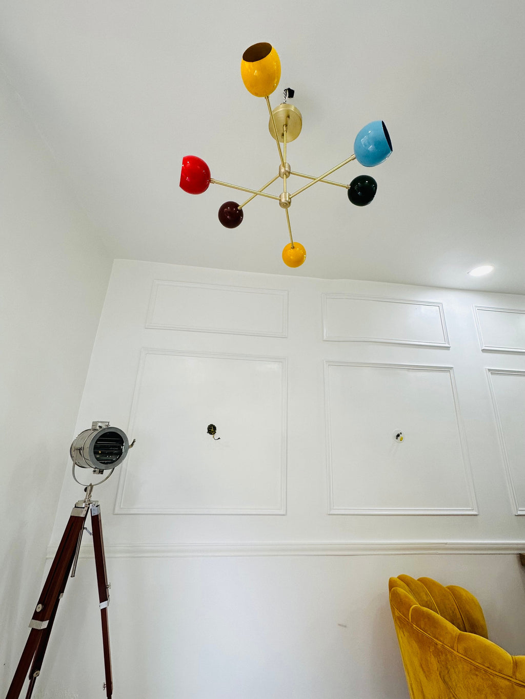Colorful ceiling lamp with multicolored spherical lights on a white wall.