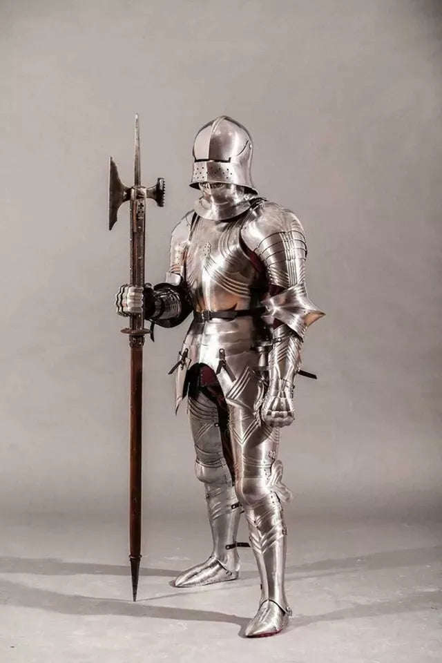 Person wearing full medieval armor holding a spear on a plain background