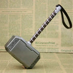 Decorative hammer with a wooden handle on a stand against a wooden background