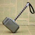 Toy hammer resembling Thor's Mjolnir on a newspaper background