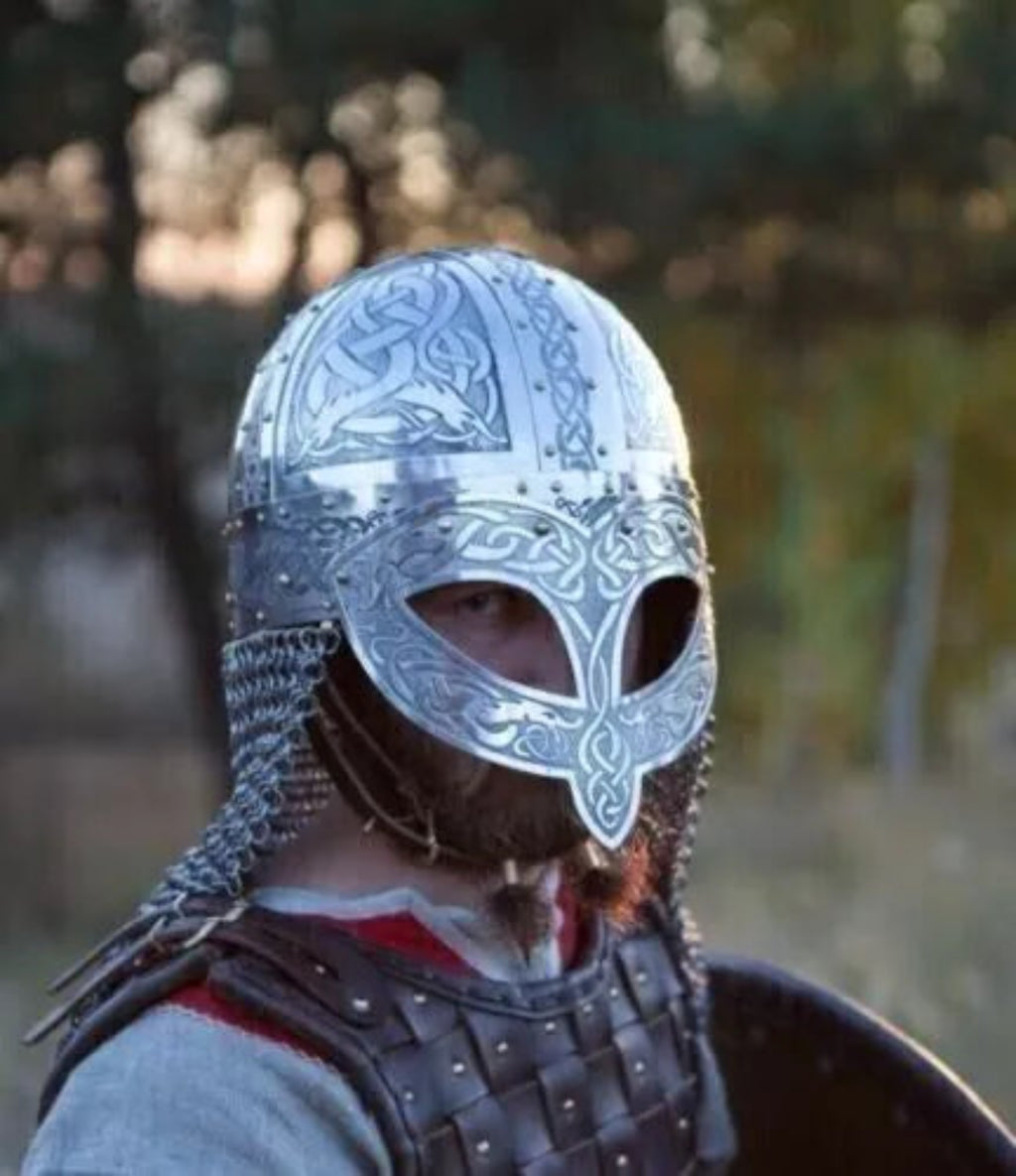 Person wearing a detailed silver helmet with a blurred natural background